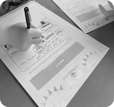 Testimonial image of a child working on one of the printable activities that is a part of the myHappymind mental health and wellbeing program.